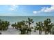 Relaxing beach view with palm trees and calm ocean at 415 L Ambiance Dr # C204, Longboat Key, FL 34228