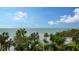 Stunning ocean view with white sand beach and palm trees at 415 L Ambiance Dr # C204, Longboat Key, FL 34228