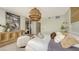 Spacious bedroom with hardwood floors, large windows and a wooden accent wall at 415 L Ambiance Dr # C204, Longboat Key, FL 34228