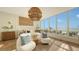 Spacious bedroom with ocean view and large windows, a king-size bed and comfy chairs at 415 L Ambiance Dr # C204, Longboat Key, FL 34228