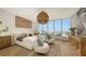 Main bedroom with ocean view, king-size bed, and light wood floors at 415 L Ambiance Dr # C204, Longboat Key, FL 34228