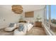 Bright bedroom with a large window, hardwood floors, and a comfortable bed at 415 L Ambiance Dr # C204, Longboat Key, FL 34228