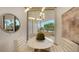 Bright breakfast nook with white table and chairs, offering a view to a balcony at 415 L Ambiance Dr # C204, Longboat Key, FL 34228