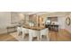 Modern dining room with a large wooden table, six chairs, and open kitchen view at 415 L Ambiance Dr # C204, Longboat Key, FL 34228
