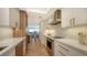 Modern kitchen with white and wood cabinets and stainless steel appliances at 415 L Ambiance Dr # C204, Longboat Key, FL 34228