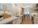Modern kitchen with white cabinets, stainless steel appliances, and quartz countertops at 415 L Ambiance Dr # C204, Longboat Key, FL 34228