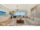 Light-filled living room with sectional sofa, coffee table, and stunning ocean view at 415 L Ambiance Dr # C204, Longboat Key, FL 34228