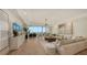 Spacious living room features hardwood floors, sectional sofa, and large windows with an ocean view at 415 L Ambiance Dr # C204, Longboat Key, FL 34228