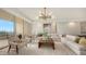 Comfortable living room with sectional sofa, armchair, and ocean view at 415 L Ambiance Dr # C204, Longboat Key, FL 34228