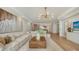 Bright living room with sectional sofa, coffee table, and ocean view at 415 L Ambiance Dr # C204, Longboat Key, FL 34228