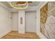 Modern lobby with elevator access and stylish wall art at 415 L Ambiance Dr # C204, Longboat Key, FL 34228