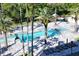 Relaxing pool area with lounge chairs and palm trees at 415 L Ambiance Dr # C204, Longboat Key, FL 34228
