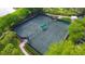 Two well-maintained tennis courts with seating area at 415 L Ambiance Dr # C204, Longboat Key, FL 34228