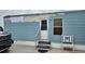 Mobile home exterior with light blue siding, small steps, and a white bench at 4207 13Th E St, Ellenton, FL 34222