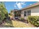 Landscaped backyard with screened patio and lush greenery at 5050 Maymont Park, Bradenton, FL 34203