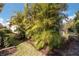 Side yard with tropical landscaping and palm trees at 5050 Maymont Park, Bradenton, FL 34203