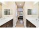 Double vanity bathroom with hallway to bedroom at 5050 Maymont Park, Bradenton, FL 34203