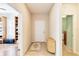 Bright entryway with light flooring and a wooden cabinet at 5050 Maymont Park, Bradenton, FL 34203