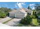 Two-story house with tile roof, two car garage, and well manicured lawn at 5050 Maymont Park, Bradenton, FL 34203