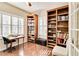Spacious home office with hardwood floors and abundant shelving at 5050 Maymont Park, Bradenton, FL 34203