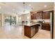 Open kitchen with island, stainless steel appliances, and view to living area at 5050 Maymont Park, Bradenton, FL 34203