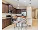 Modern kitchen featuring dark wood cabinets and granite countertops at 5050 Maymont Park, Bradenton, FL 34203