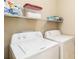 Laundry room with washer, dryer, and shelving at 5050 Maymont Park, Bradenton, FL 34203