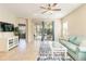 Bright living room with light teal sofa and access to backyard patio at 5050 Maymont Park, Bradenton, FL 34203
