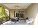 Covered patio with glass sliding doors, ceiling fan and outdoor seating at 5050 Maymont Park, Bradenton, FL 34203