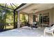 Relaxing screened patio with seating area, ceiling fan, and access to backyard at 5050 Maymont Park, Bradenton, FL 34203