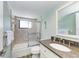 Clean bathroom with a tub shower, granite countertop, and updated fixtures at 5613 Gulf Dr, Holmes Beach, FL 34217