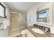 Updated bathroom with a walk-in shower, granite vanity, and stylish decor at 5613 Gulf Dr, Holmes Beach, FL 34217