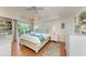 Main bedroom with a king-size bed, built-in shelving, and private balcony at 5613 Gulf Dr, Holmes Beach, FL 34217