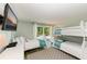 Bedroom with twin beds, TV and sliding door access to patio at 5613 Gulf Dr, Holmes Beach, FL 34217