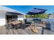 Large deck with dining and seating areas, umbrellas, and ocean views at 5613 Gulf Dr, Holmes Beach, FL 34217