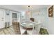 Bright dining area with glass-top table and wicker chairs at 5613 Gulf Dr, Holmes Beach, FL 34217