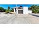Front view of a contemporary home with a garage at 5613 Gulf Dr, Holmes Beach, FL 34217