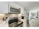 Kitchen with stainless steel appliances and white cabinetry at 5613 Gulf Dr, Holmes Beach, FL 34217