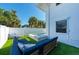 Blue sectional sofa and modern pool in backyard at 5613 Gulf Dr, Holmes Beach, FL 34217