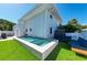 Luxury pool, patio furniture, and grassy backyard at 5613 Gulf Dr, Holmes Beach, FL 34217