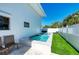 Relaxing pool area with artificial turf and lounge chairs at 5613 Gulf Dr, Holmes Beach, FL 34217