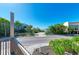 Oceanfront lot with tropical landscaping and a paved street at 5613 Gulf Dr, Holmes Beach, FL 34217