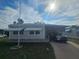 Single-wide mobile home with carport and landscaping at 5619 Bayshore Rd # 115, Palmetto, FL 34221