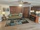 Living room with sofa, wood-look floors, and fireplace at 5619 Bayshore Rd # 115, Palmetto, FL 34221