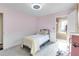 Light pink bedroom with a twin bed and access to a walk-in closet at 5726 Aaron Ct, Sarasota, FL 34232
