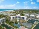 Aerial view of waterfront community with tennis courts, pool, and marina at 5855 Midnight Pass Rd # 311, Sarasota, FL 34242
