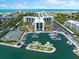 Aerial view of condo complex with marina, pool, and tennis courts at 5855 Midnight Pass Rd # 311, Sarasota, FL 34242