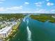 Aerial view of boats traveling through a waterway near waterfront homes at 5855 Midnight Pass Rd # 311, Sarasota, FL 34242