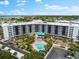 Aerial view of condo building with pool and parking at 5855 Midnight Pass Rd # 311, Sarasota, FL 34242