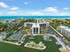 Aerial view of waterfront community with tennis courts, marina, and ocean access at 5855 Midnight Pass Rd # 311, Sarasota, FL 34242